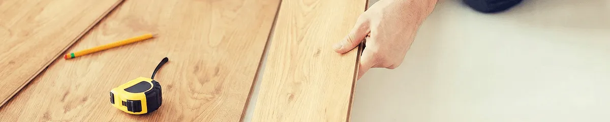 A professional installing wood flooring in Peoria, IL