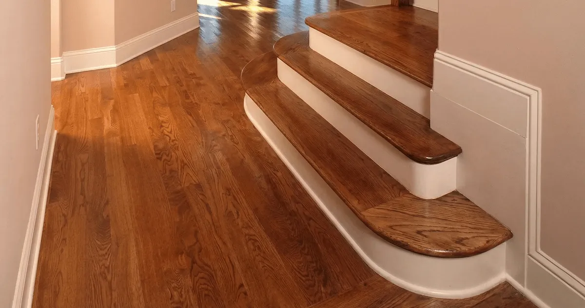 Base floor of a staircase with professionally restored wood flooring in Peoria IL